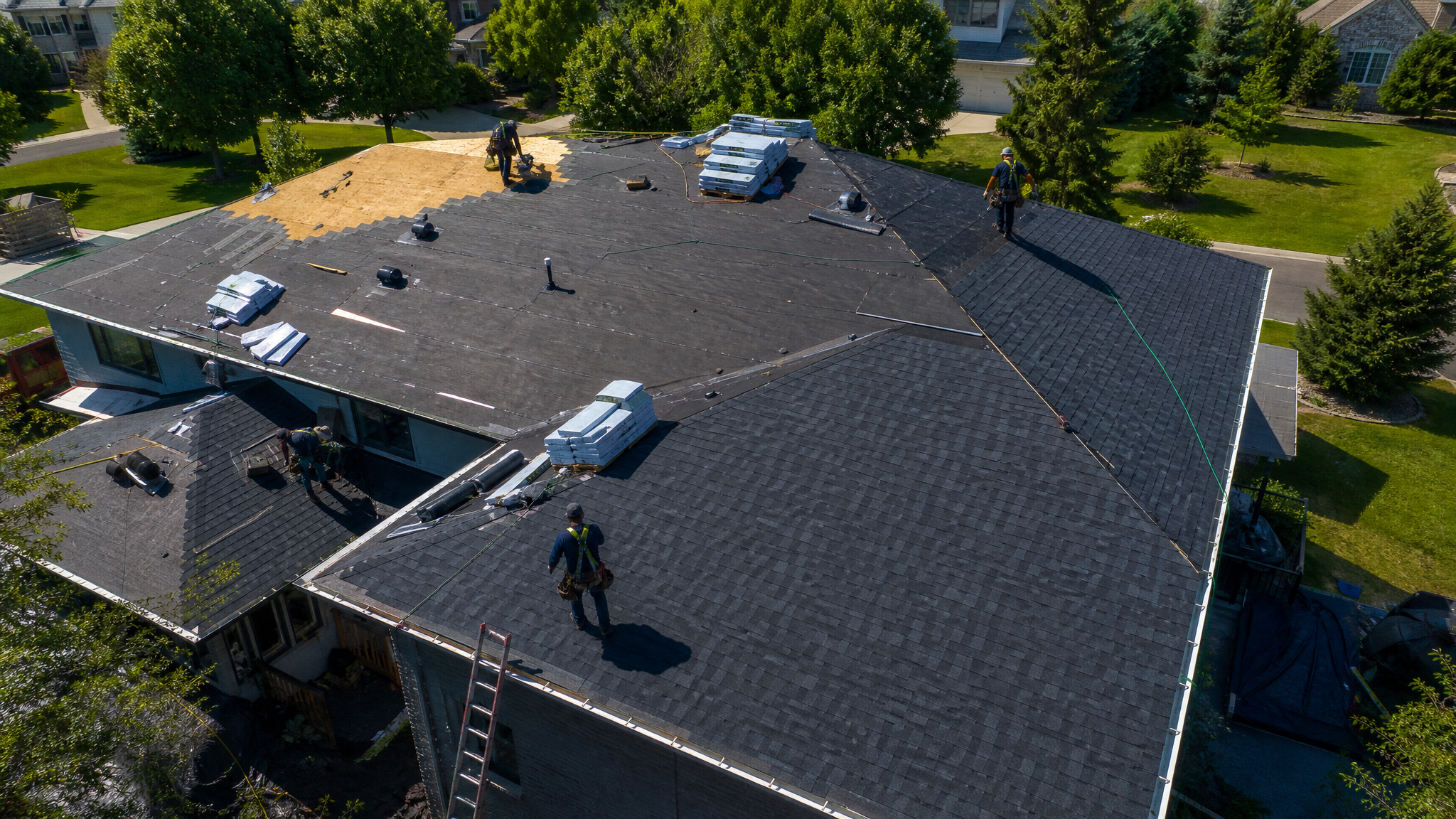 Drone view of a residential roof replacement crew for Regan Roofing, Inc.
